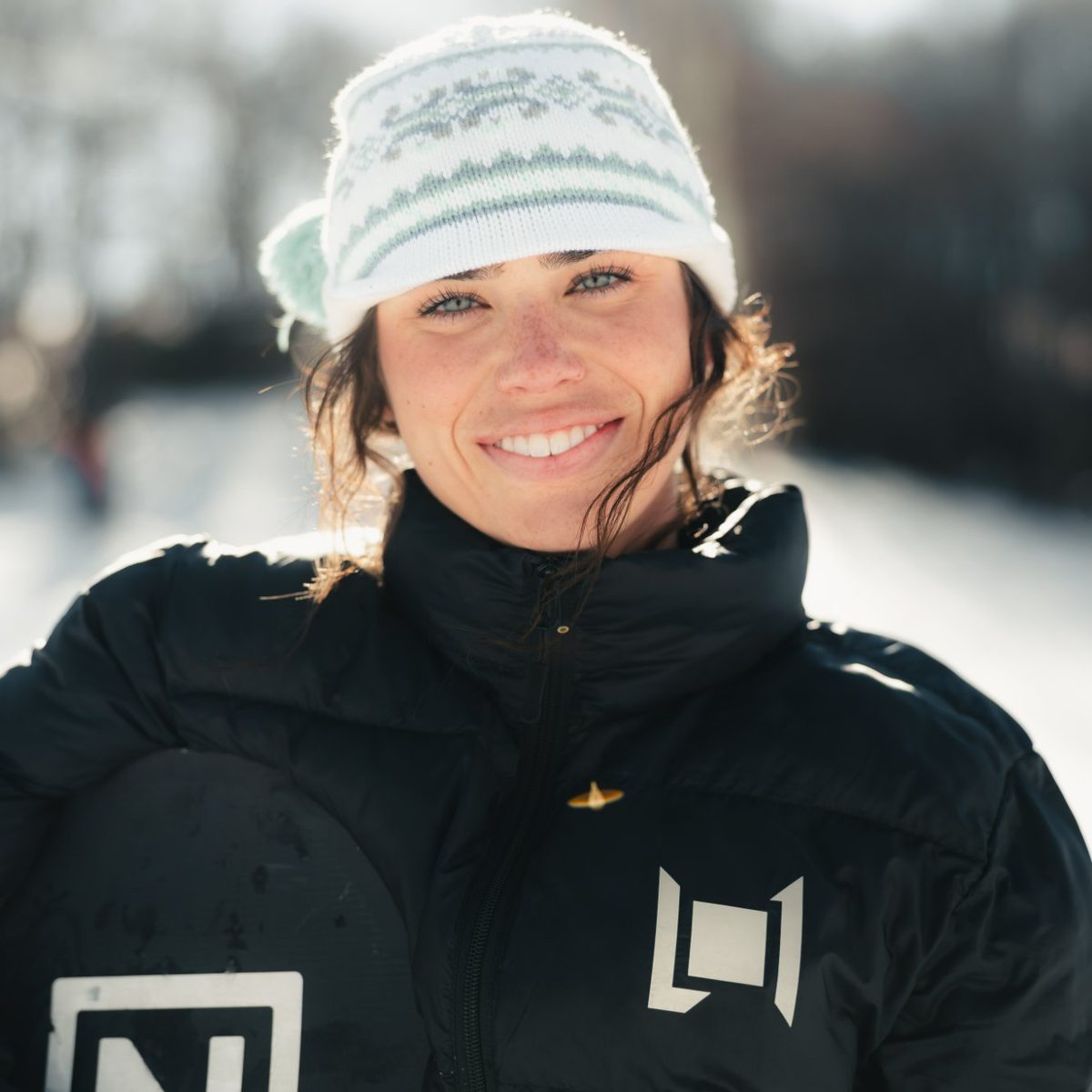 Brantley Mullins with her snowboard in the sun