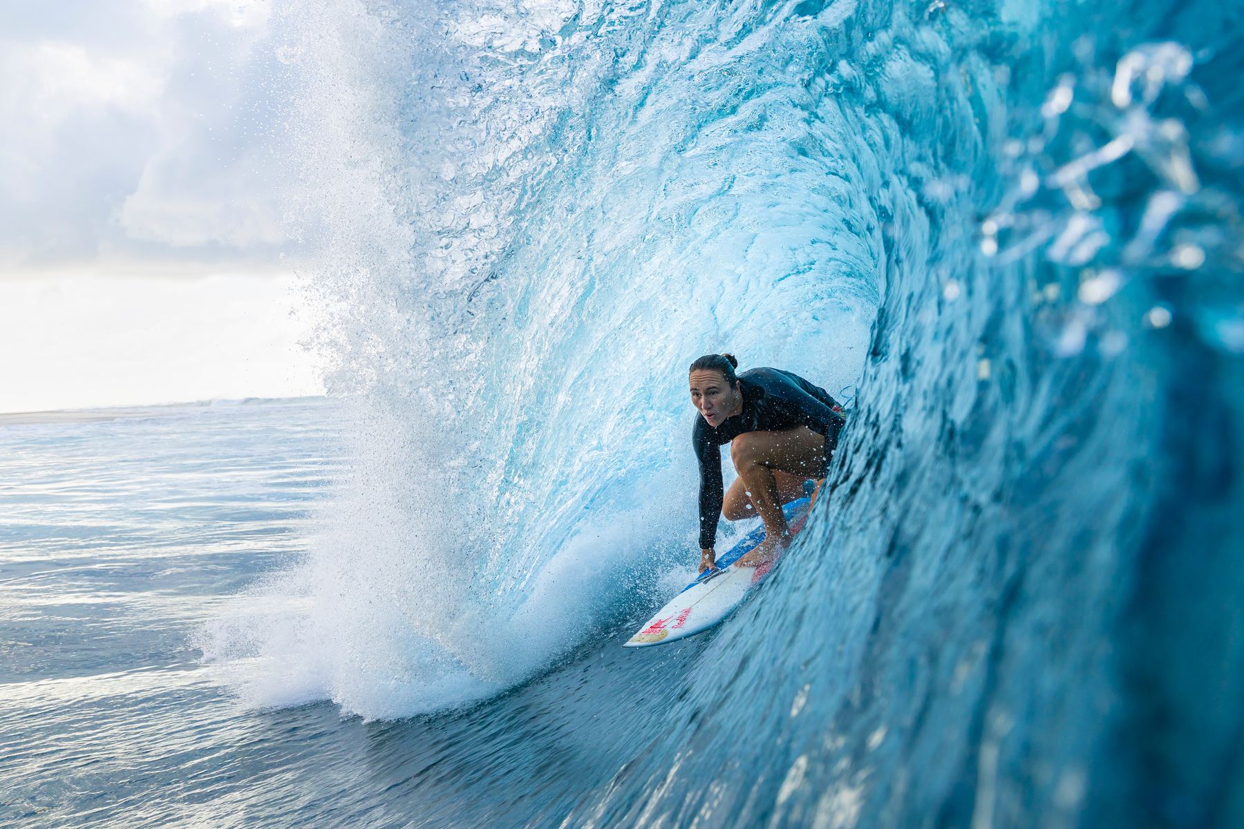 Carissa Moore crouched deep inside a barrel